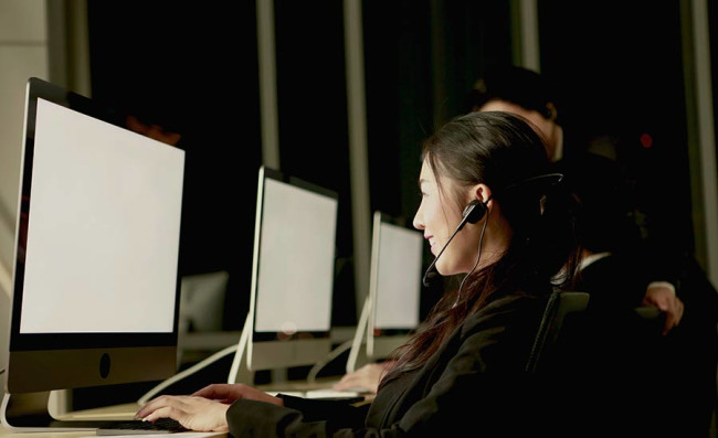 Customer service representative with headset working at night